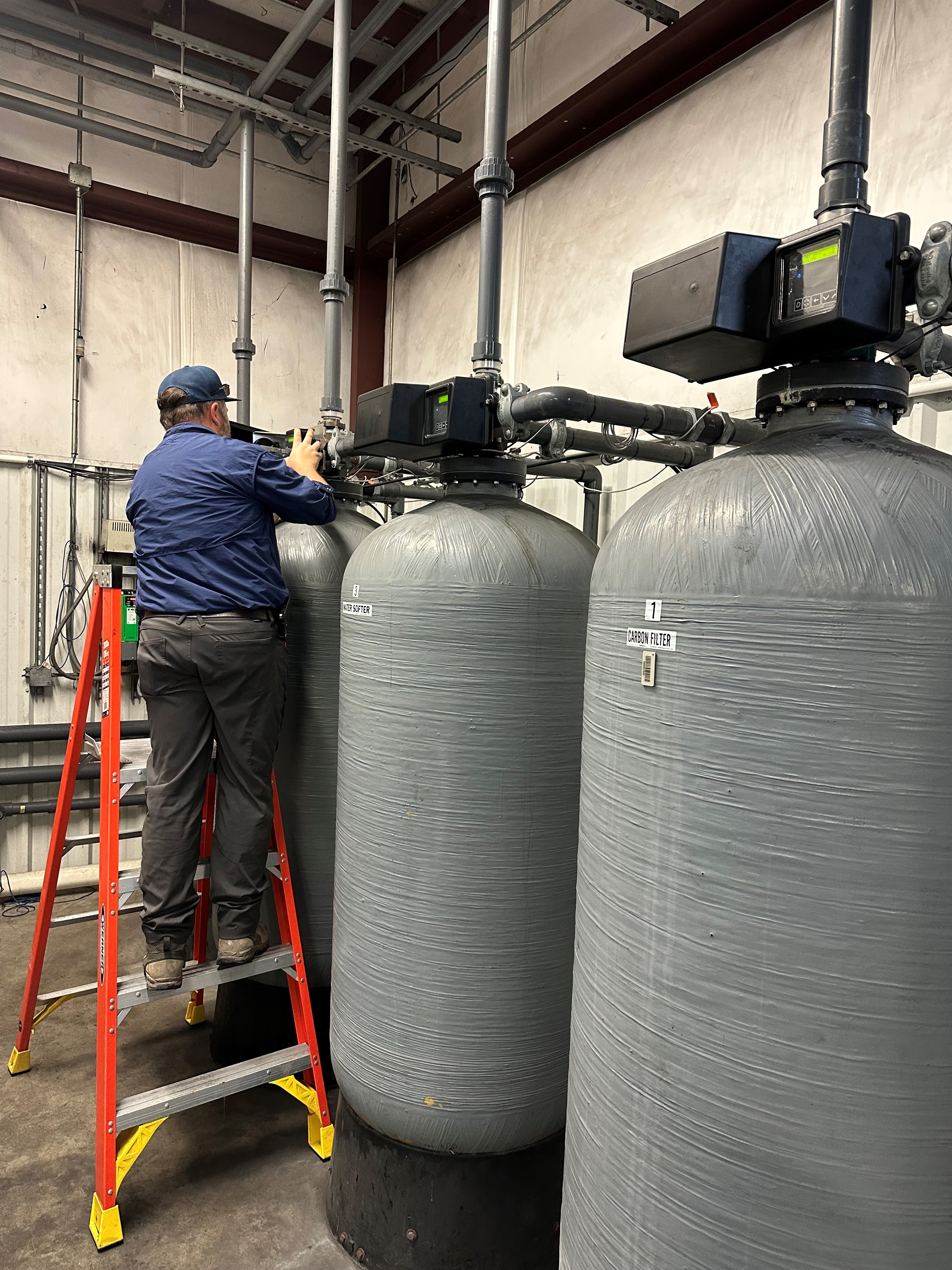 Mueller Water technician servicing water treatment equipment