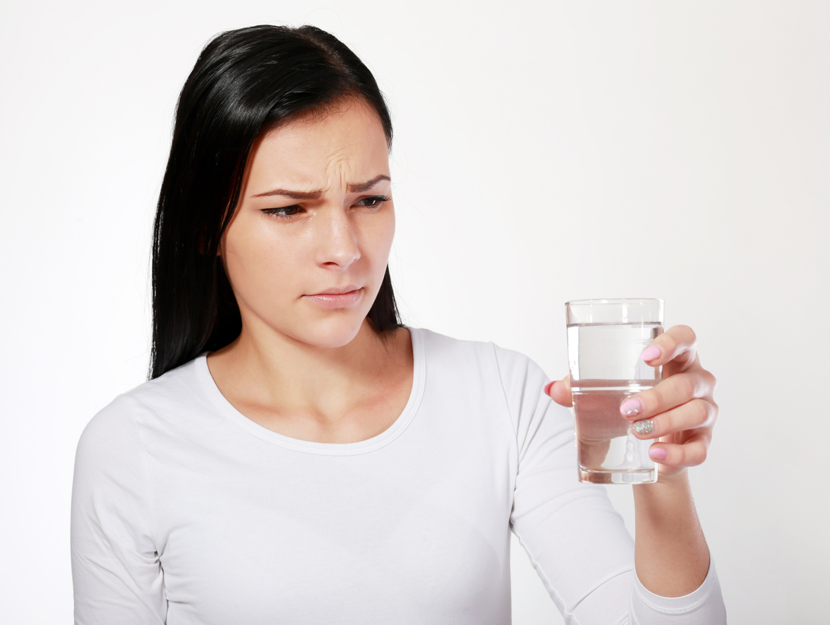 Person reacting to bad-smelling water from a household faucet